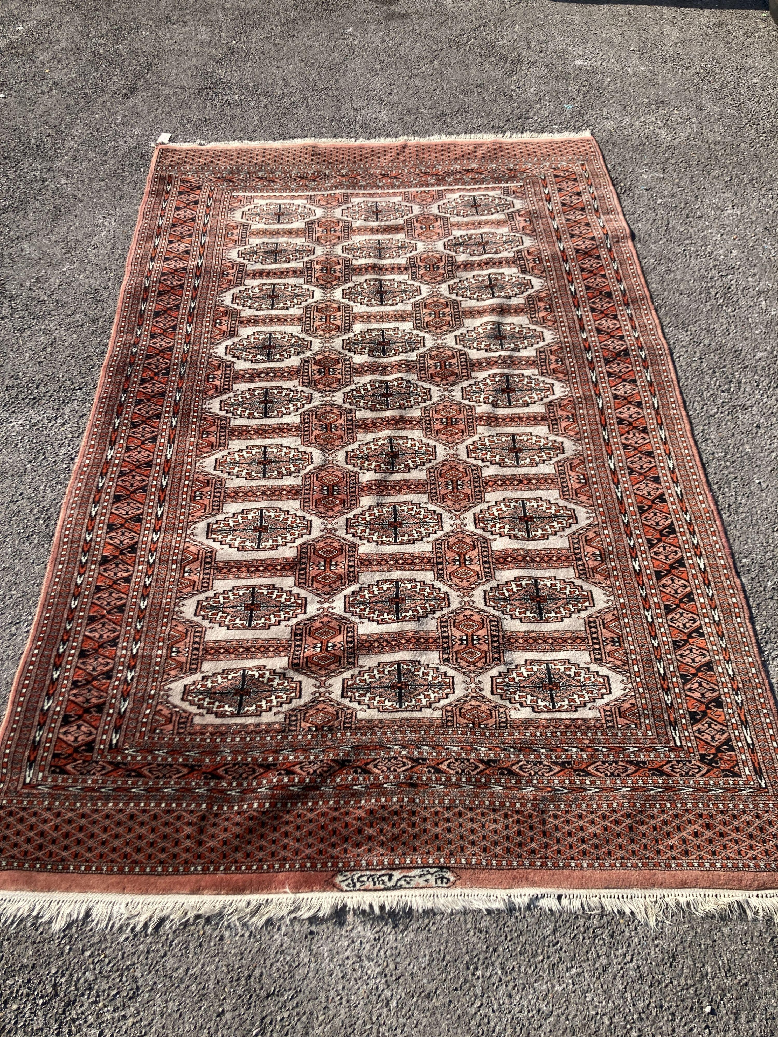 A pale red ground Tekke rug with signed border, 260 x 162cm